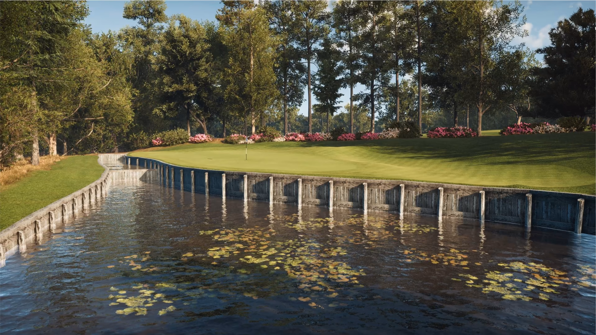 Golf-course green beside water and trees